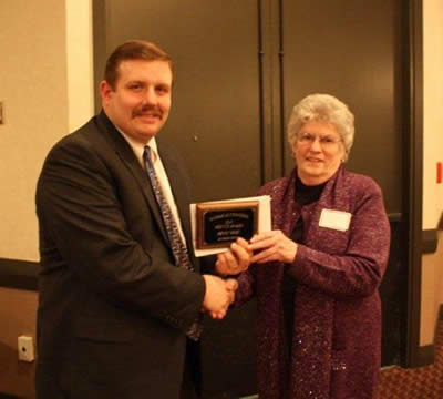Andy Conser presents the 2010 Service Award to Peggy Giles, Ag Press. Andy Conser presents the 2010 Service Award to Peggy Giles, Ag Press.