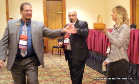NAA representative Rich Schur rings while Shawn Terrel NAA representative Rich Schur rings while Shawn Terrel