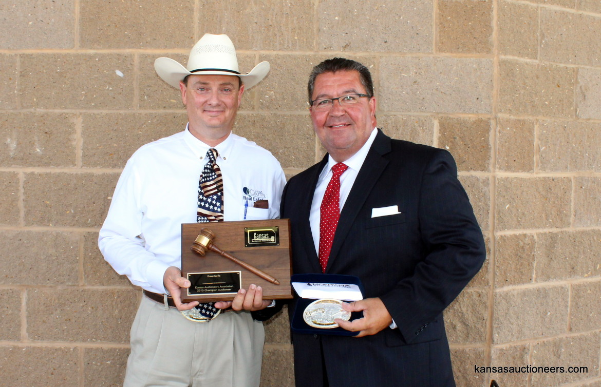 Lance Fullerton, 2014 Champion, presents Lenny Mullin with the 2015 Kansas Auctioneer Championship belt buckle and plaque. Lance Fullerton, 2014 Champion, presents Lenny Mullin with the 2015 Kansas Auctioneer Championship belt buckle and plaque.